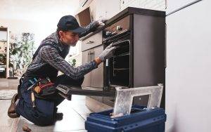 Repairman Examining Oven