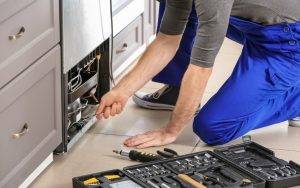 Technician Repairing Refrigerator